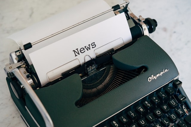 Typewriter with piece of paper that says "News"